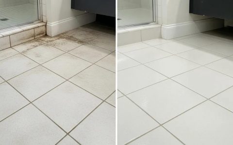 Technician steam-cleaning tile and grout in a contemporary New York City kitchen using eco-friendly methods
