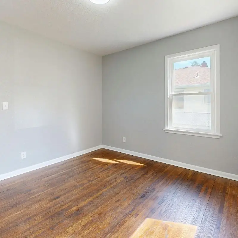 Empty room with polished hardwood floors