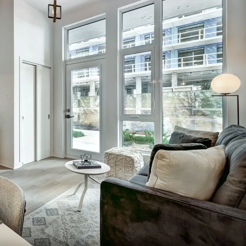 Clean living room with sofa and large windows